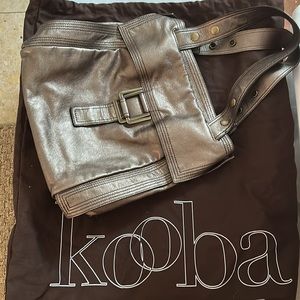 Kooba shoulder bag. Snaps on side for more volume. Comes with dust bag.